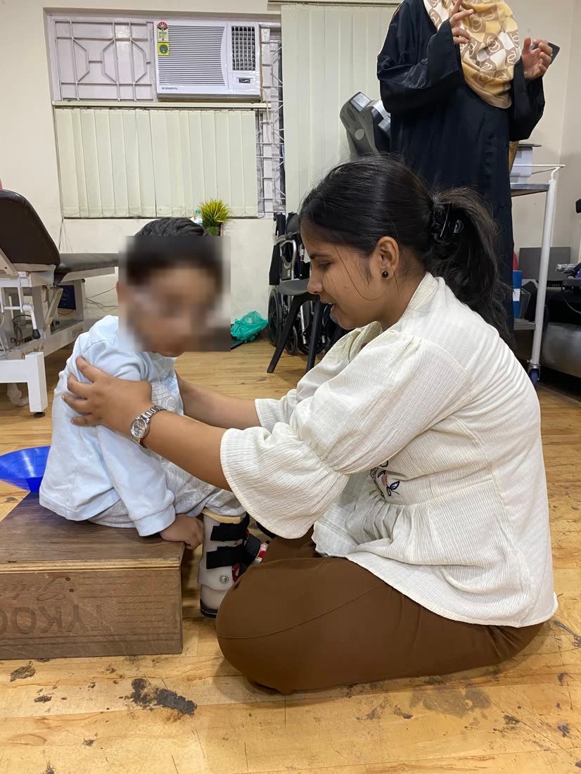 Female physiotherapist working with a young child during a paediatric session at Physiotrix Ballygunge