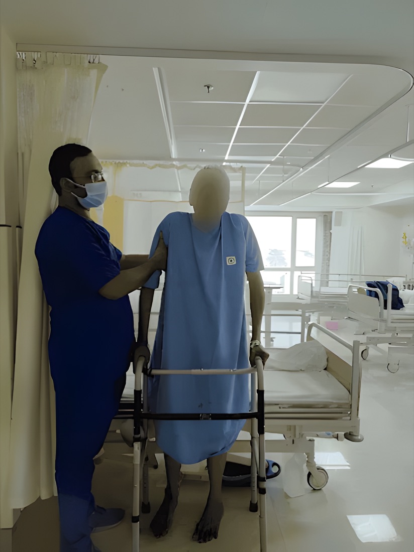 Physiotherapist guiding a patient walking with a walker frame at Physiotrix, Behala